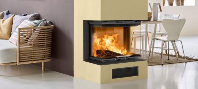 Large yellow fireplace near the middle wall which separate kitchen from living room